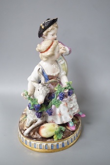 A 19th century Meissen figure group of a boy with a pipe, a girl with a grape and a goat, crossed swords in blue, incise letters and numbers. 15cm